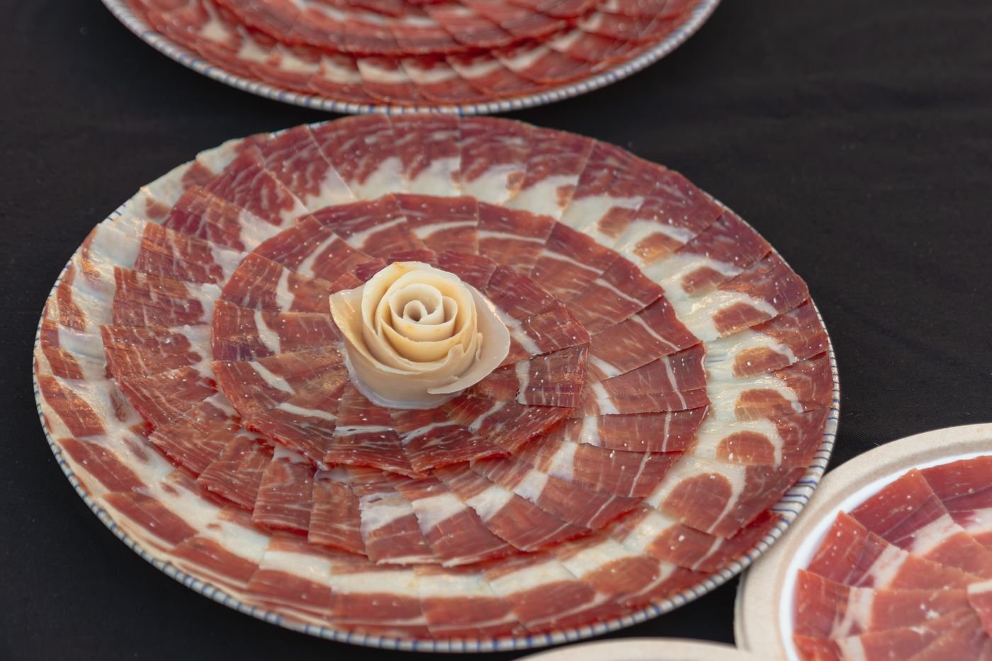 Mesa con platos de jamón ibérico cortado a cuchillo
